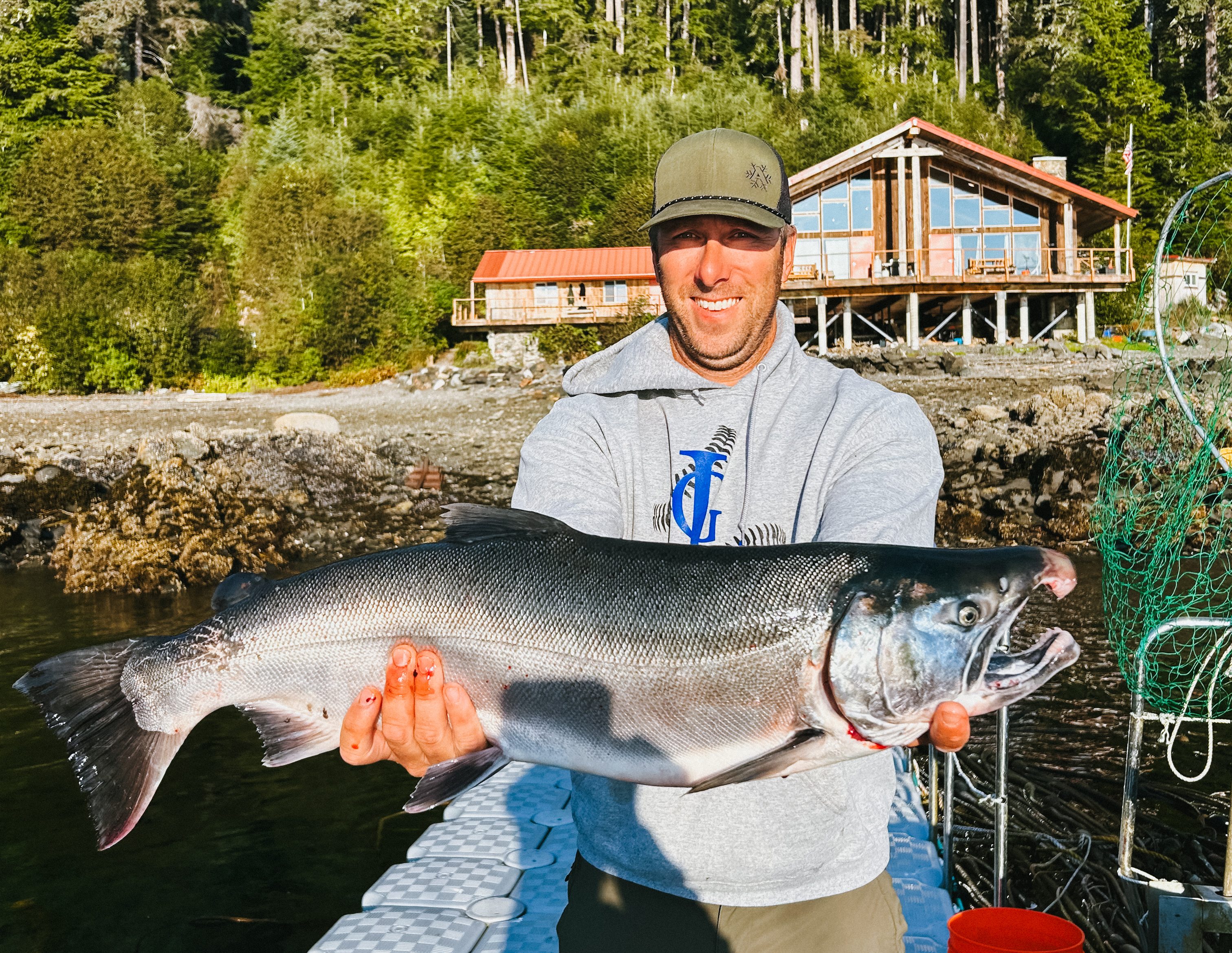Guest on an Alaska fishing trip holding up a halibut at Salmon Run Fishing Lodge